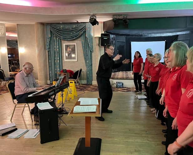 Douglas Coombes rehearsing the choir