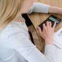 Busy woman working at home office calculating and paying utility bills for house rent.