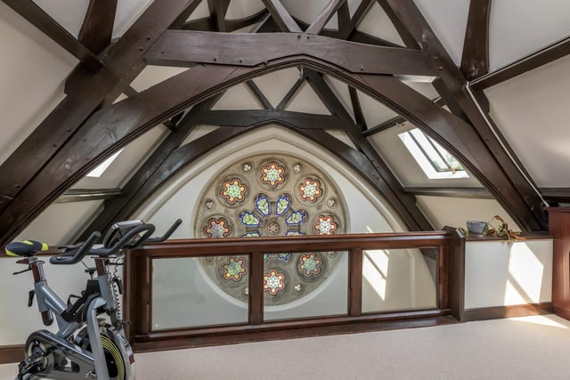 This stunning circular stained glass window is a focal point of the property.