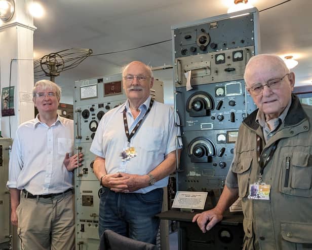 Left to right: Volunteers Nick Gilder, Alf Fisher, and Dave Thompson at a 1940s World War Two air traffic control desk. Image: Dave Thompson.