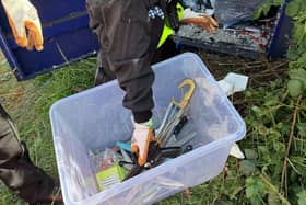 Officers emptying knife bins