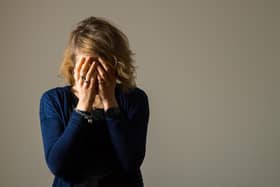 File photo of a woman with her hands covering her face. Picture posed by model.