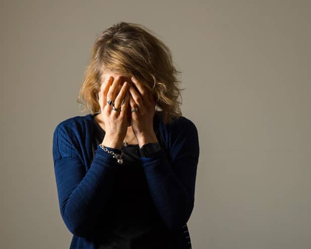 File photo of a woman with her hands covering her face. Picture posed by model.