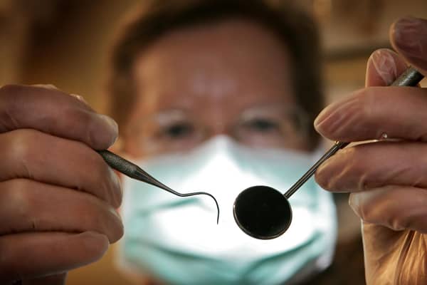 A patient's eye view, as a dentist poses for the photographer. Photo by Peter Macdiarmid/Getty Images