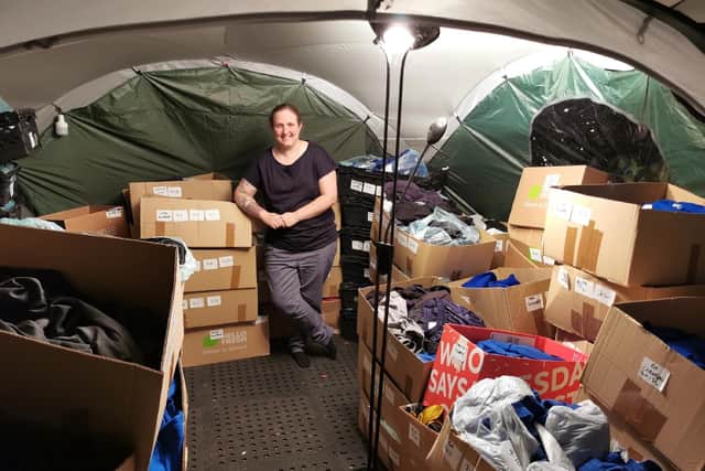 Amy surrounded by boxes of donations. Image: Amy Foster.