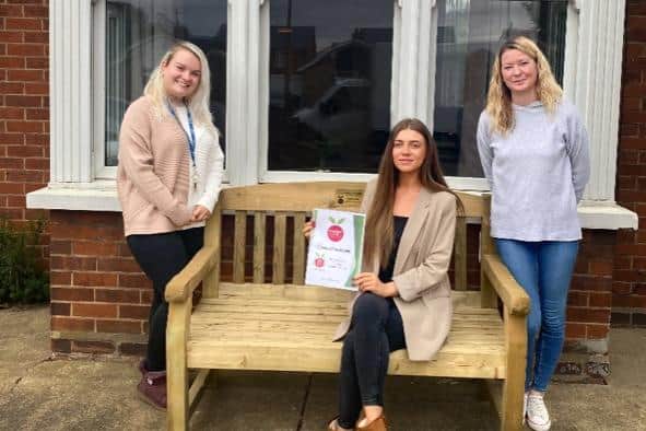 Hollycroft House staff with the new bench. Left to right: Malindi Warne - support worker, Sian Hall - registered manager, and Emma Cox - senior support worker. Image: Hollycroft House.