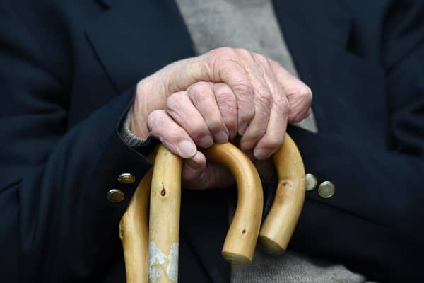 File photo of an elderly man holding a walking stick.