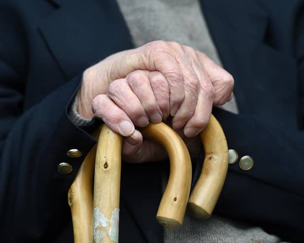 File photo of an elderly man holding a walking stick.