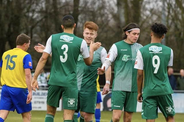 Biggleswade FC's Alex Marsh is congratulated after completing his hat-trick against Hertford. Photo: Guy Wills.