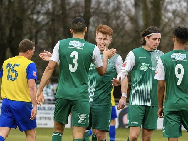 Biggleswade FC's Alex Marsh is congratulated after completing his hat-trick against Hertford. Photo: Guy Wills.