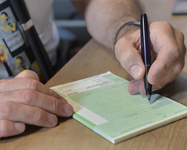 A GP writing out a prescription