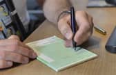 A GP writing out a prescription