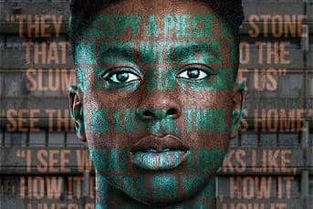 Actor Olatunji Ayofe stood in front of council flats with play quotes over his face.