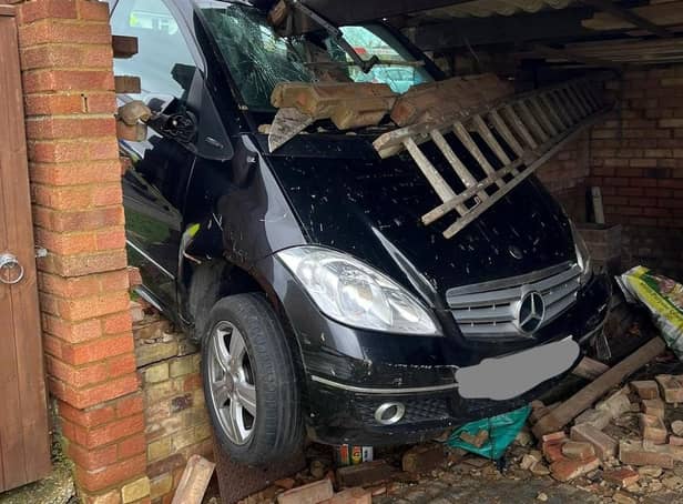 A pensioner, 83, was saved from her Mercedes after it smashed through a brick wall and got wedged in a private garage in Lower Stondon. PIC Bedfordshire Fire Control / SWNS
