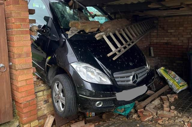 A pensioner, 83, was saved from her Mercedes after it smashed through a brick wall and got wedged in a private garage in Lower Stondon. PIC Bedfordshire Fire Control / SWNS