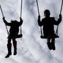 File photo dated of children playing on swings