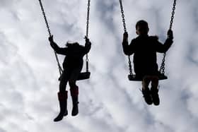 File photo dated of children playing on swings