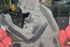 The graffiti scratched over a Remembrance display in Biggleswade