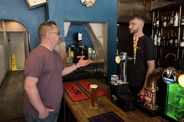 Cllr Steven Watkins speaks to a staff member in The Rose, High Street. Image supplied by Cllr Watkins.
