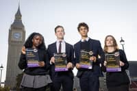 Students Eni (first name only), Labour MP Alistair Strathern, Harry Terruli and Caitlin (first name only) with 'The Unofficial Curriculum' in Parliament Square Gardens, London. Photo: Matt Alexander/Assignments/the Press Association