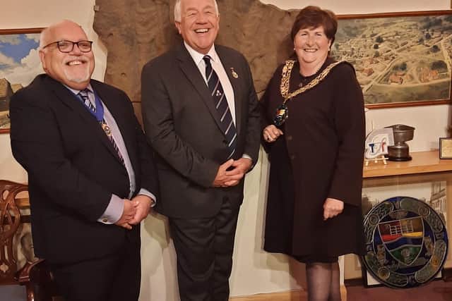 Outgoing mayor Cllr Martin Pettitt (centre) congratulates new deputy mayor Cllr Paul Sharman and mayor Cllr Joanna Hewitt.