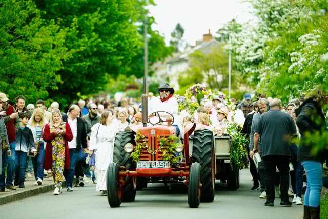 The procession under way with the infant dancers going to Ickwell in style on the trailer pulled by a tractor.