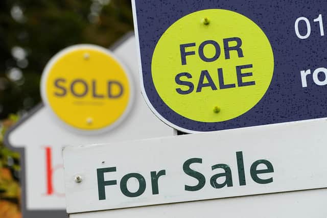 General view of Sold and For Sale signs outside a block of flats