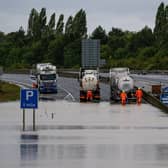 Efforts to remove flood water from the A421 after it flooded in September 2024