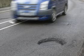 File photo of a van driving past a pothole used for illustrative purposes only.