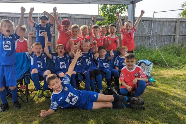 Youngsters from Potton Utd YFC celebrating getting new equipment