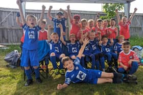 Youngsters from Potton Utd YFC celebrating getting new equipment