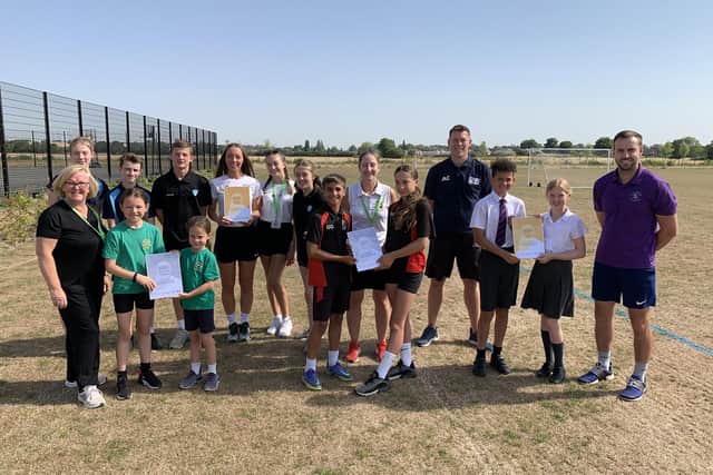Staff and pupils from Gothic Mede, Etonbury, Pix Brook and Robert Bloomfield Academies gathered together to receive their Schools Games Mark certificates from Andy Cavill of Redborne SSP, pictured fourth right. Image: BEST