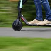 A man rides an e-scooter. (Photo by TOBIAS SCHWARZ/AFP via Getty Images)