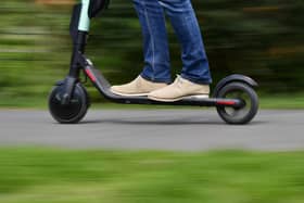 A man rides an e-scooter. (Photo by TOBIAS SCHWARZ/AFP via Getty Images)