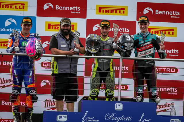 Lewis Smart on the top step of the podium with his dad Gavin taking the team award. Photo: Colin Port Images.