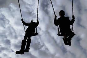 File photo of children playing on swings i