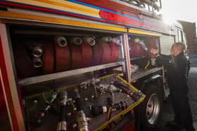 James Copley loads hoses onto a fire engine as five engines prepare to leave Leigh Community Fire Station. Photo by Anthony Devlin/Getty Images