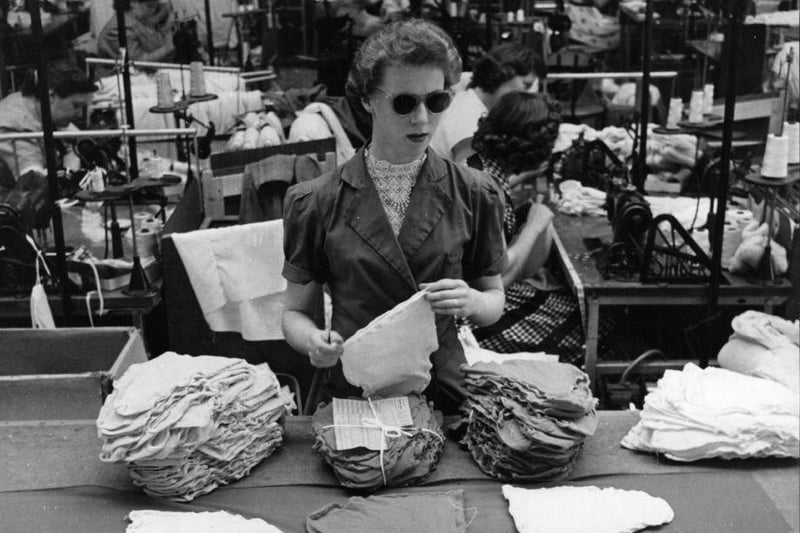 A factory worker packing luminous 'Rock 'n' Roll' knickers at the Kayser Bondor factory in Biggleswade. She is wearing sunglasses to reduce the glare.