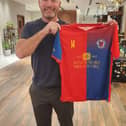 Alan Shearer with the Biggleswade United shirt.
