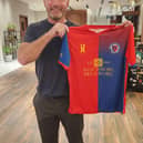 Alan Shearer with the Biggleswade United shirt.