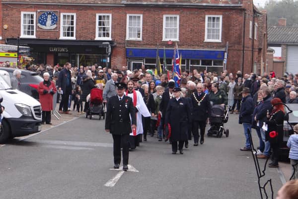 The head of the parade steps out from the Market Square, led by Potton's Town Crier and Fire Brigade Chief, Carlton Avison. Image: Kieran Evetts.