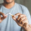 File photo of a man breaking a cigarette