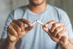 File photo of a man breaking a cigarette
