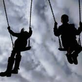 File photo  of children playing on swings in a park