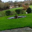 Charlie Bond hits the water after plummeting through the trampoline