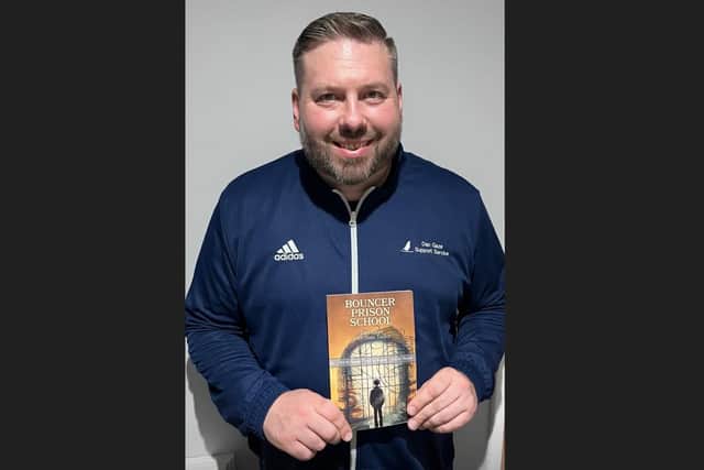 Dan Gaze with his new book, Bouncer Prison School. Image: Dan Gaze.