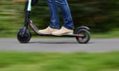 File photo of a person on an e-scooter (Photo by TOBIAS SCHWARZ/AFP via Getty Images)