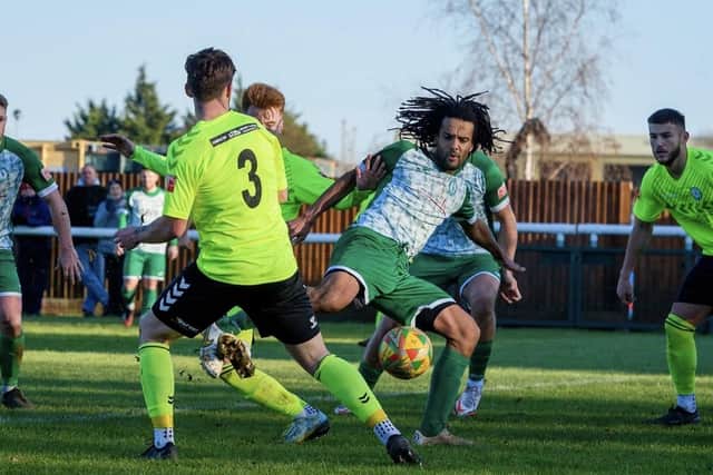 Action from Biggleswade Town's (in dark green) clash with Biggleswade FC. Photo: Guy Wills Photography.