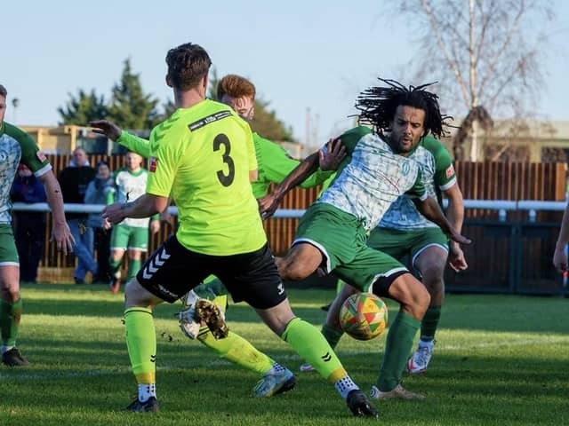 Action from Biggleswade Town's (in dark green) clash with Biggleswade FC. Photo: Guy Wills Photography.