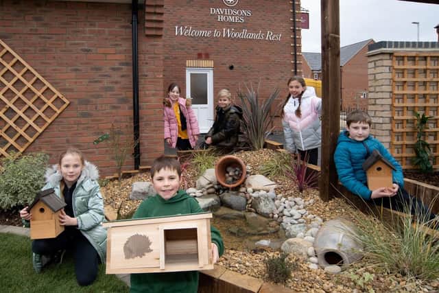 Pupils show off some of the eco-friendly elements of the garden